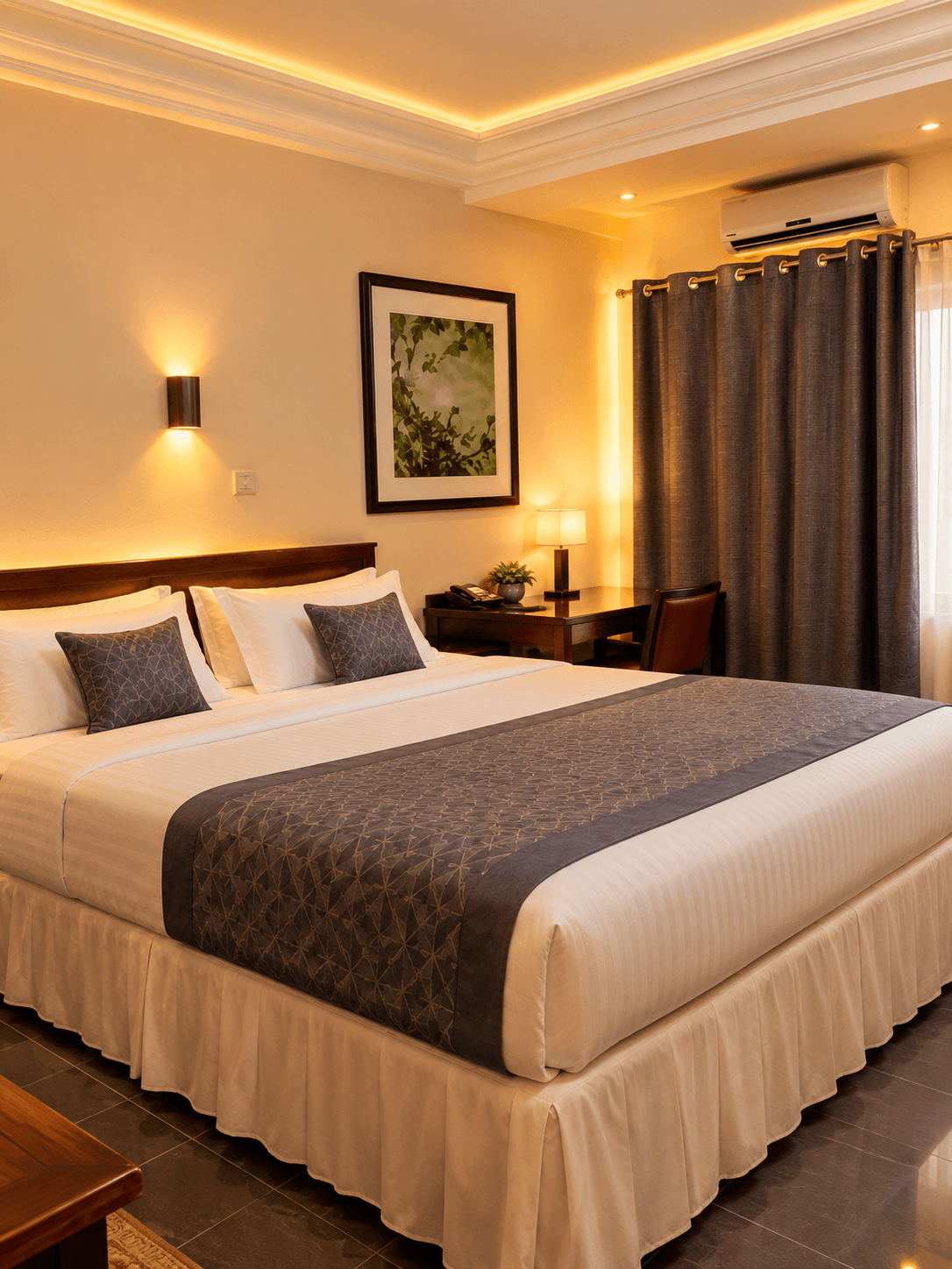 Guest room with a made bed, warm lamps and a window onto the city